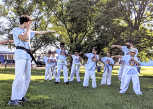 Kids practicing karate in the park during Camp Kokoro